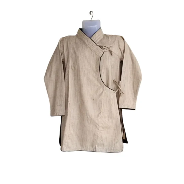Close-up of beige Daura wrap top with black piping and tie knots