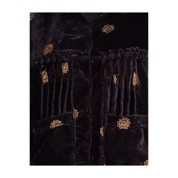 Close-up of gathered pleats and gold butti on velvet Cholo