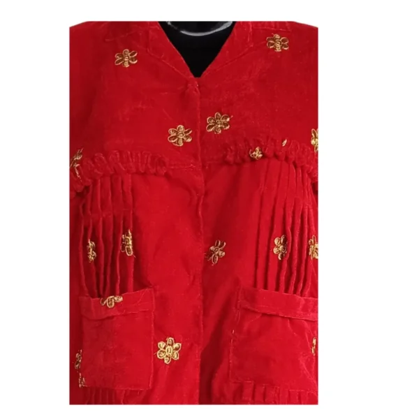 Close-up of pleated yoke and gold butti on red Cholo