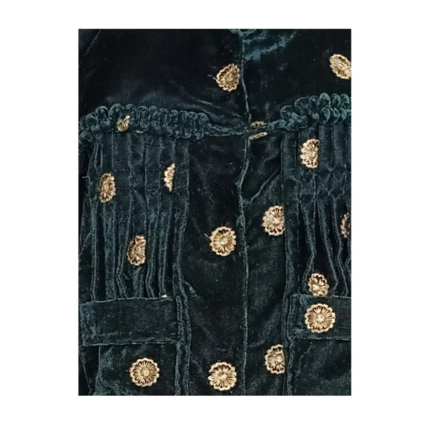 Close-up of pleats and gold butti on green velvet Cholo