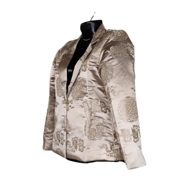 Side view of champagne brocade Kuchin coat with lapel and frog buttons