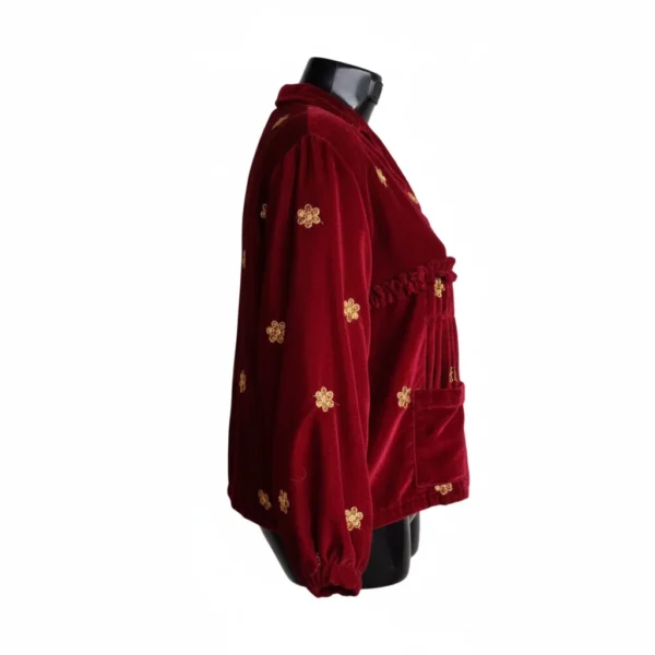 Side view of maroon velvet Rai Cholo with gold butti and pockets