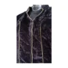 Close-up of gold piping and velvet texture on black blouse
