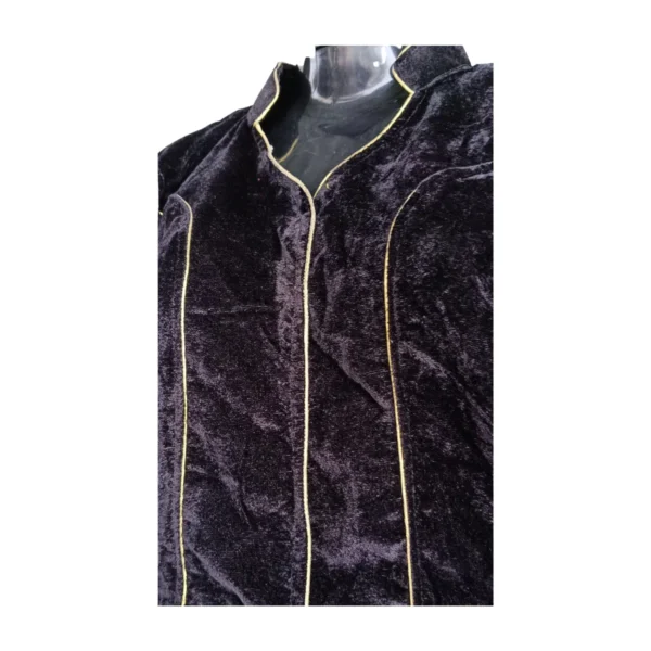 Close-up of gold piping and velvet texture on black blouse