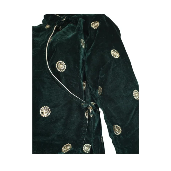 Detail of green velvet cholo showing side tie and piping