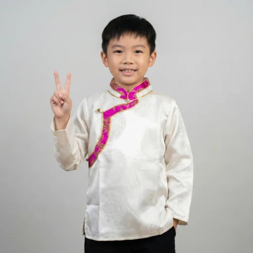boy in Ivory jacquard Khenja with pink Tash Kuchin border