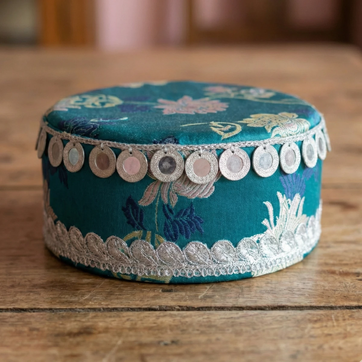 Tamang wedding topi in teal Tash Kuchin fabric with silver coin embellishments and motis Tamang wedding topi in teal Tash Kuchin fabric with silver coin embellishments and motis