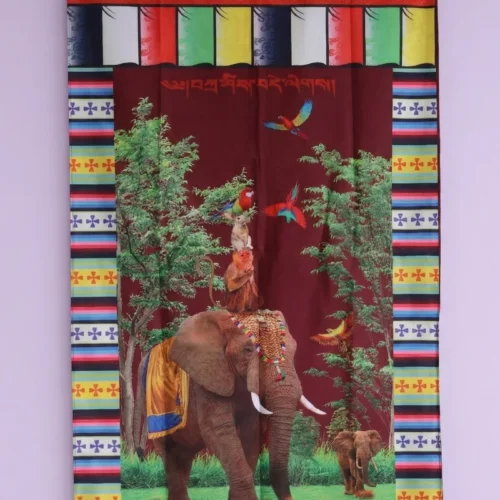 Tibetan door curtain with caparisoned elephant, monkeys, and parrots on maroon — auspicious wildlife motif