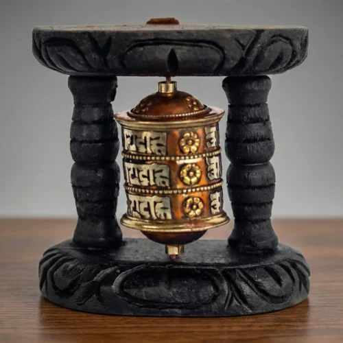 Tibetan prayer wheel front view — three-row Om Mani Padme Hum Uchen script on copper-brass wheel — home altar