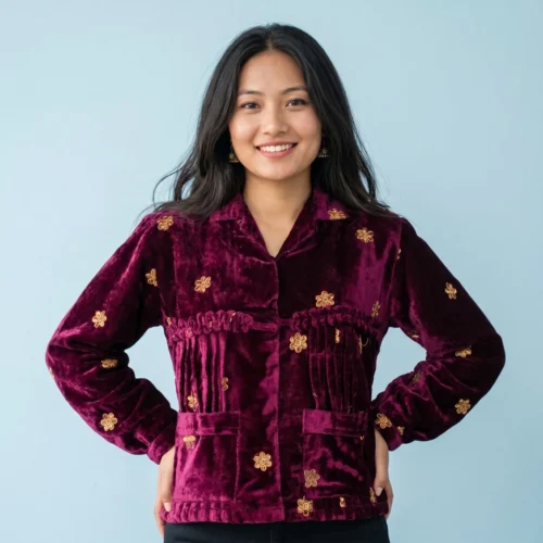 Woman wearing Wine velvet Rai Cholo with handcrafted gold motifs full body front view