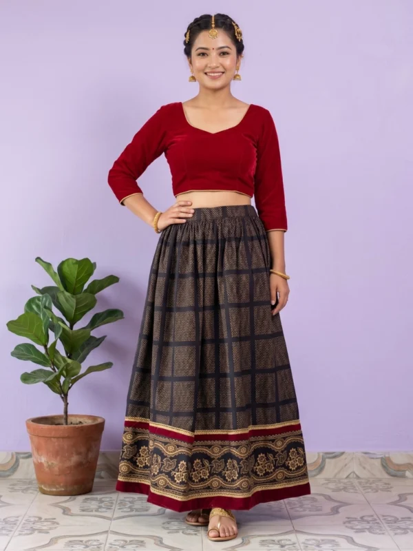 Woman wearing black gold patterned Nepali lehenga front view full length