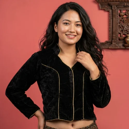 Woman wearing black velvet mandarin collar blouse front view with carved backdrop