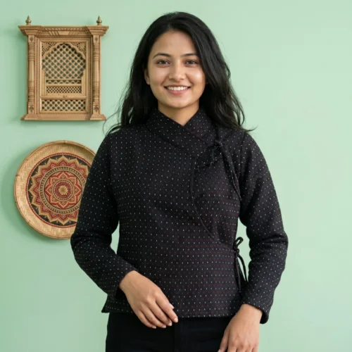 Woman wearing in dot pattern Newari Chaubandi cholo front view with cultural backdrop