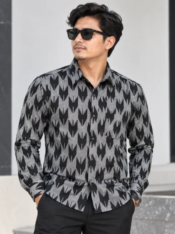 Man wearing black and grey Nepali Dhaka print shirt, front view