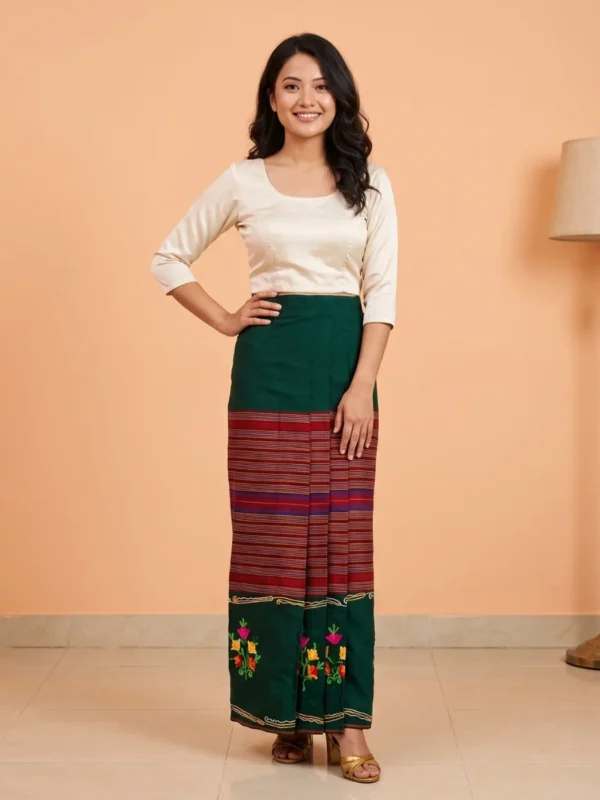 Woman wearing green embroidered tamang wrapper phariya, front view