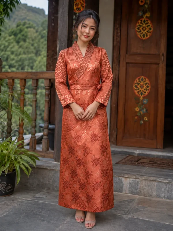 Woman wearing rust jacquard bakhu dress with tonal sleeves front view