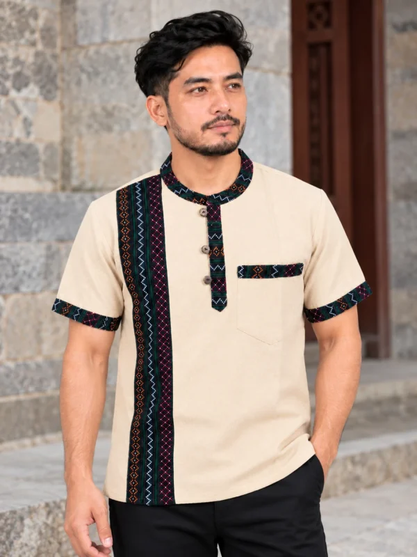 Man wearing beige newari shirt with woven band newari dress for men front view