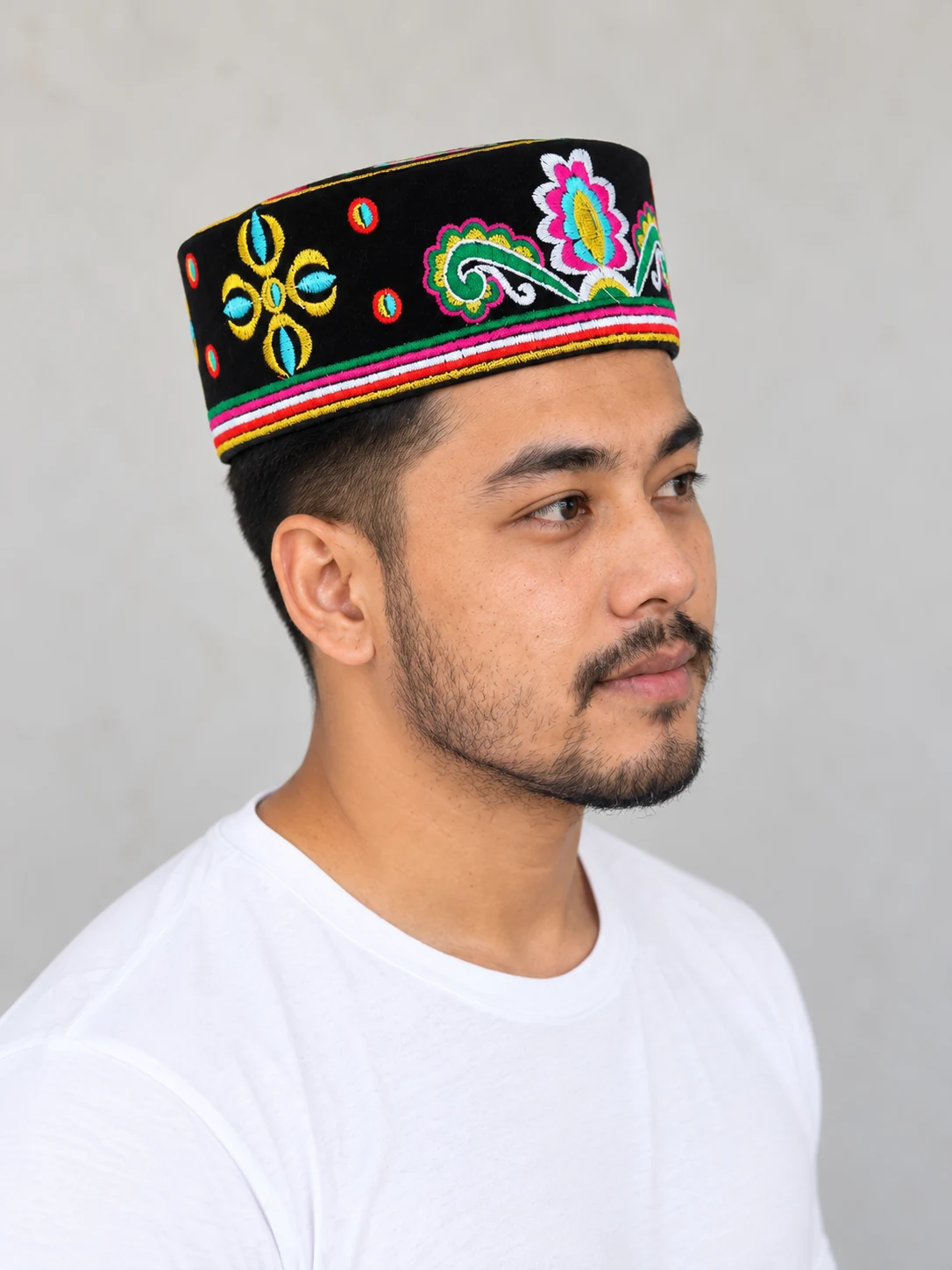 Embroidered Velvet Tamang Topi for Men 25 Man wearing black embroidered velvet topi side view