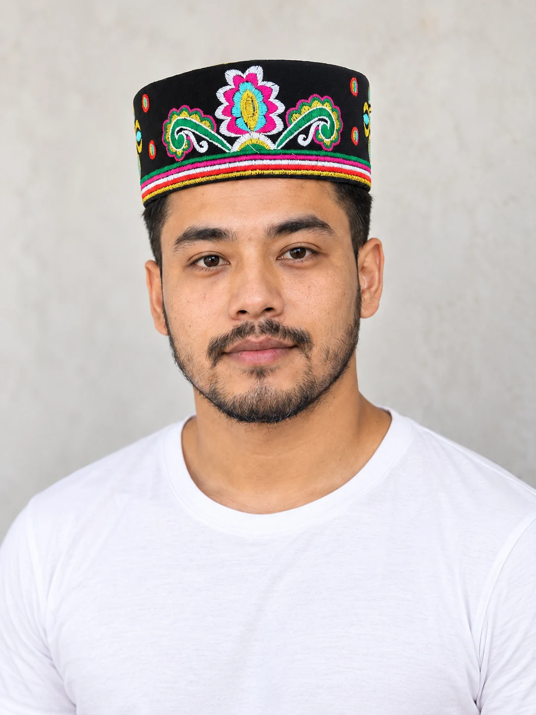 Embroidered Velvet Tamang Topi for Men 24 Man wearing black embroidered velvet topi three quarter view