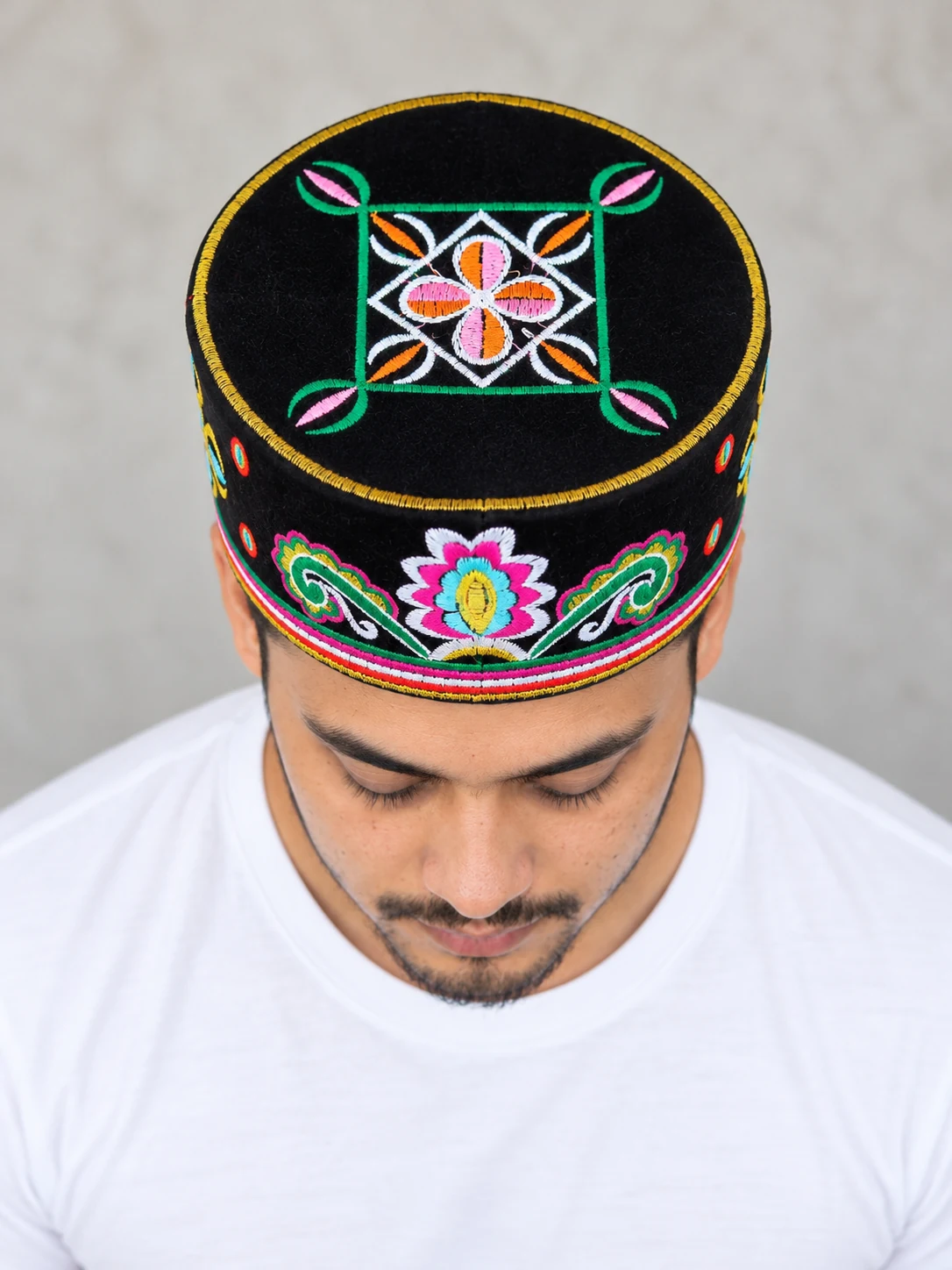 Embroidered Velvet Tamang Topi for Men 27 Man wearing black embroidered velvet topi top view
