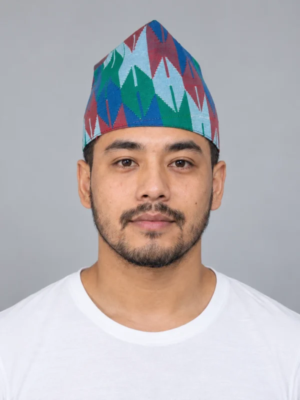 Man wearing blue green chevron nepali dhaka topi front view