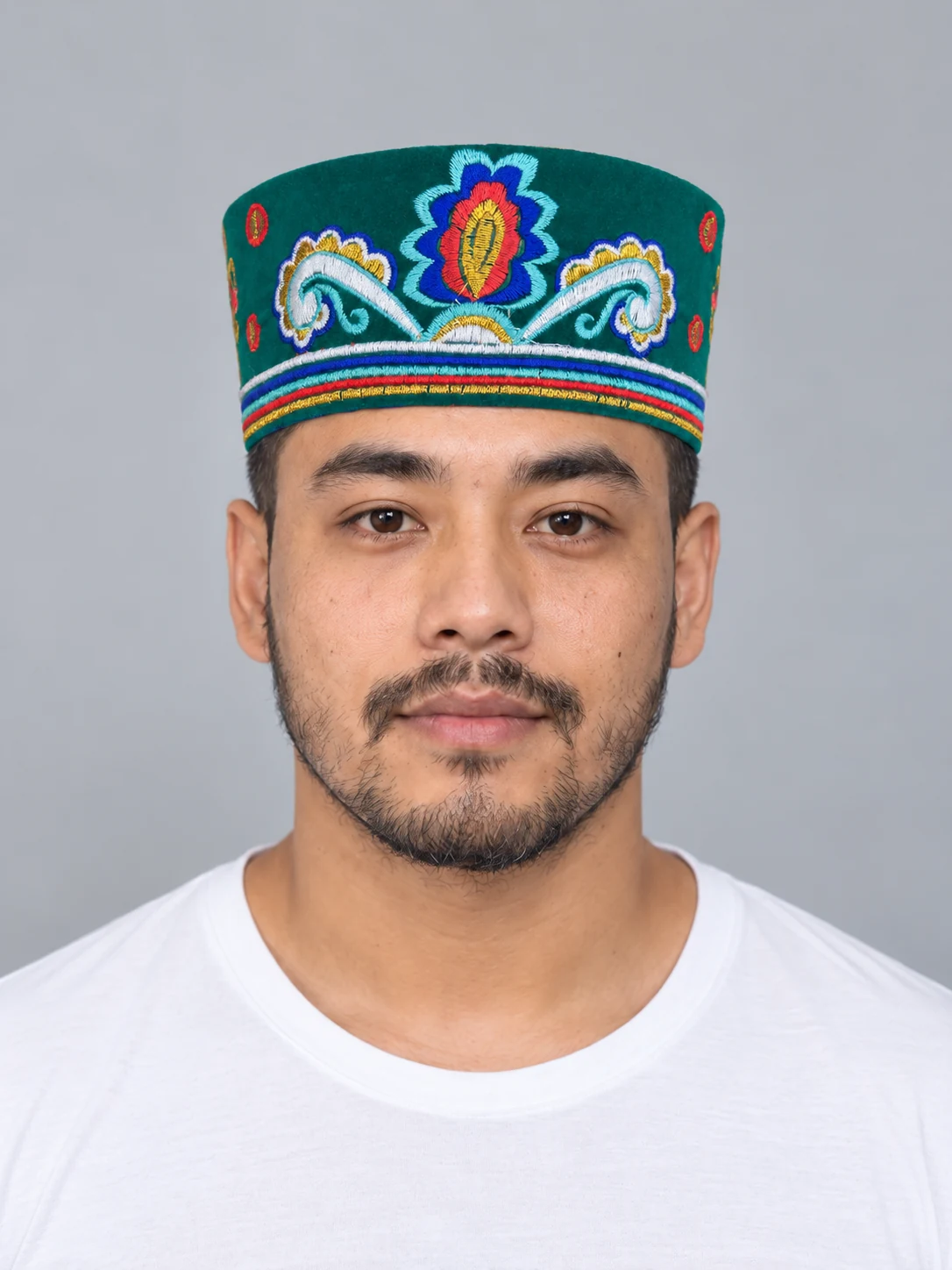 Embroidered Velvet Tamang Topi for Men 7 Man wearing emerald embroidered velvet topi front view