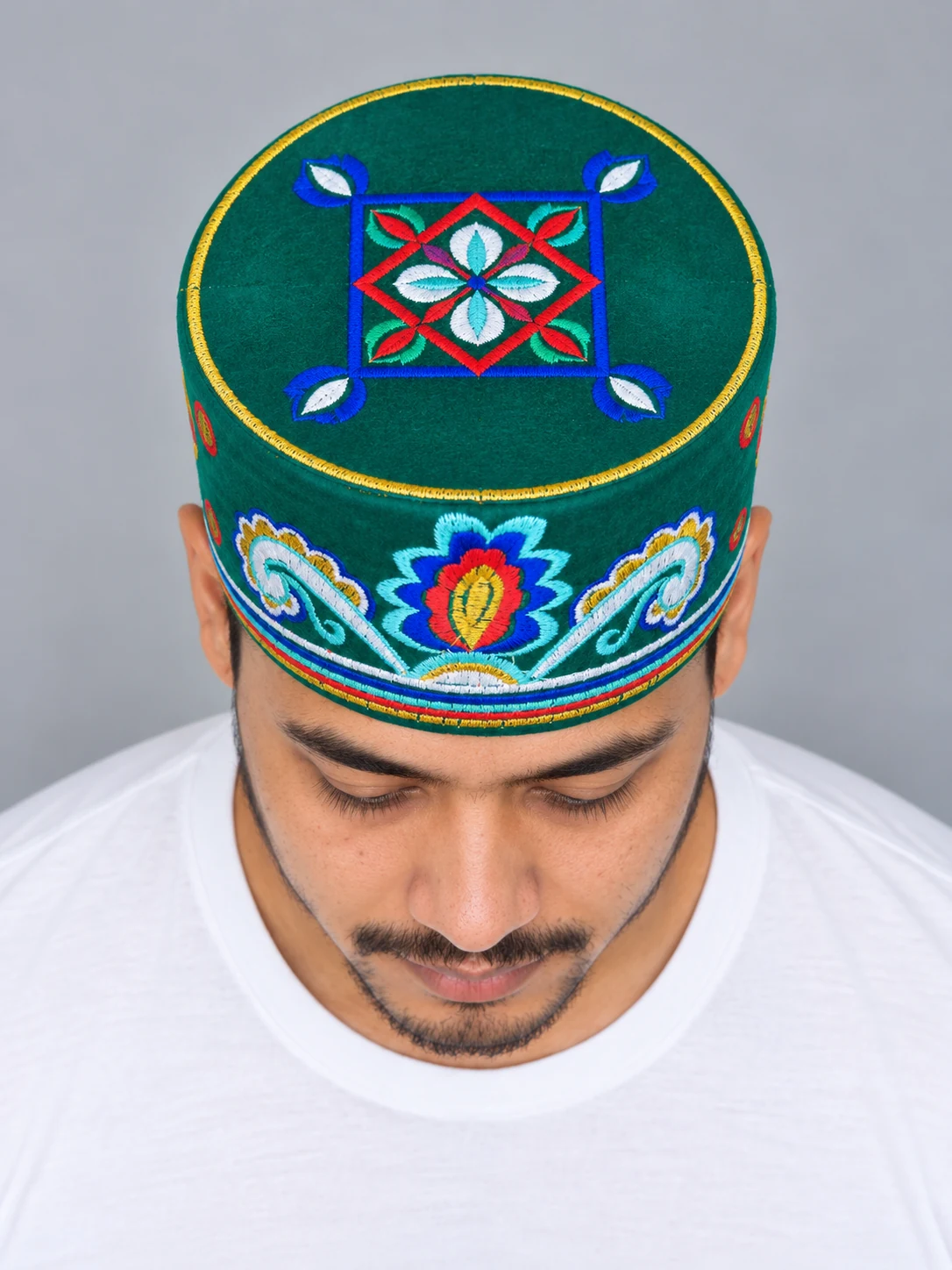 Embroidered Velvet Tamang Topi for Men 11 Man wearing emerald embroidered velvet topi top view