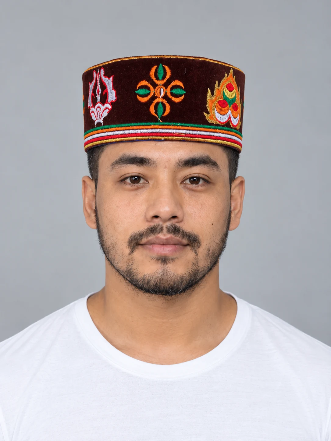Embroidered Velvet Tamang Topi for Men 1 Man wearing maroon tamang hat front view