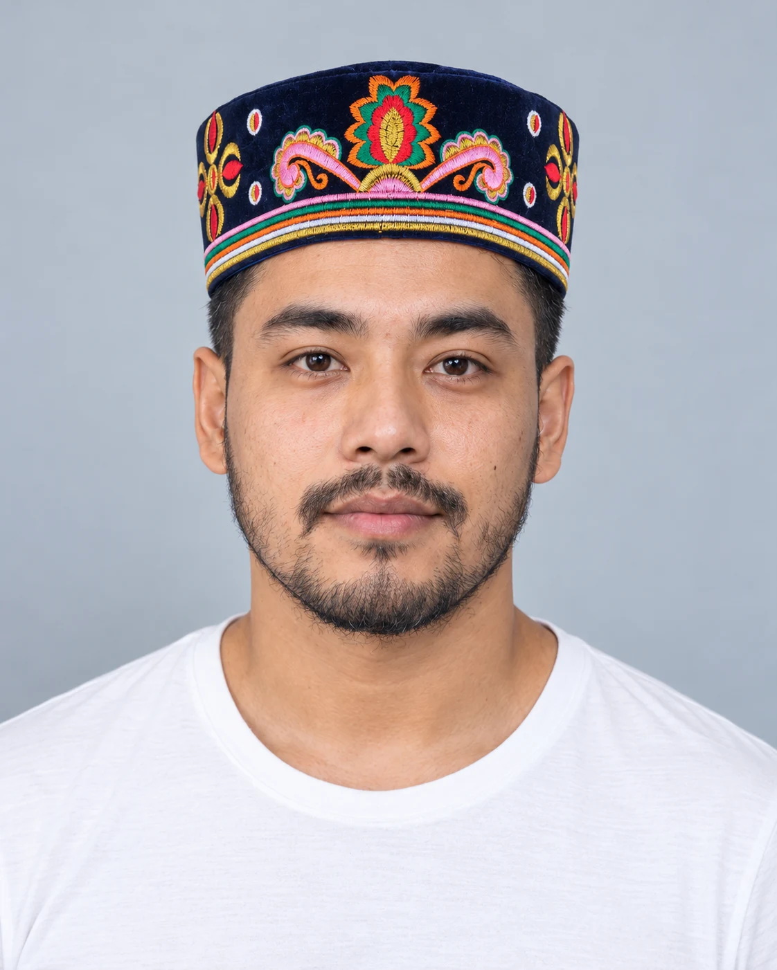 Embroidered Velvet Tamang Topi for Men 13 Man wearing navy blue embroidered velvet topi front view