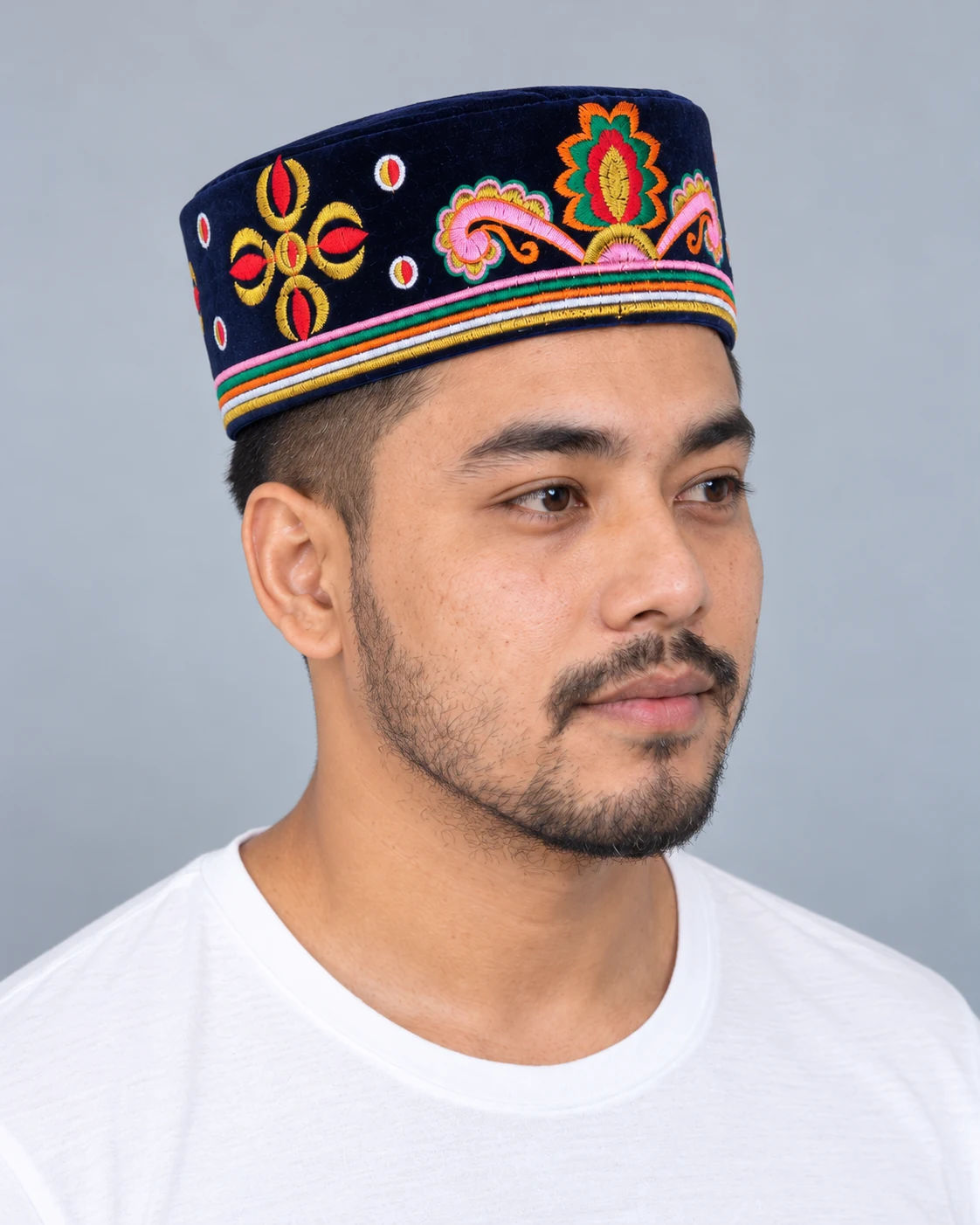 Embroidered Velvet Tamang Topi for Men 14 Man wearing navy blue embroidered velvet topi three quarter view
