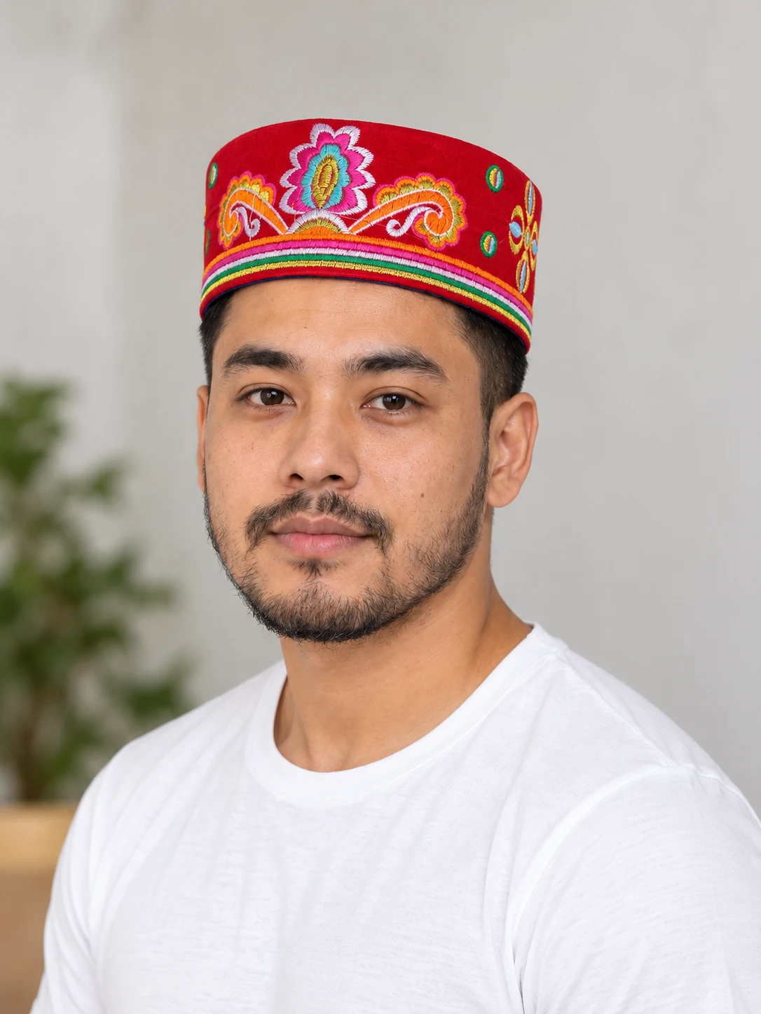 Embroidered Velvet Tamang Topi for Men 18 Man wearing red embroidered velvet topi front view