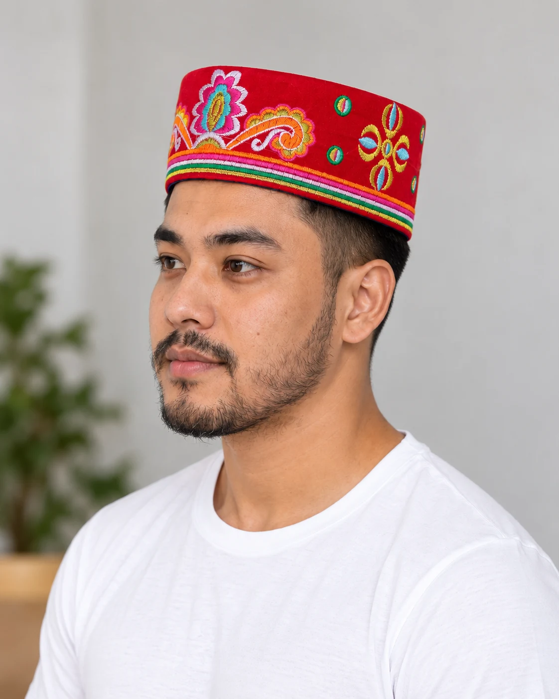 Embroidered Velvet Tamang Topi for Men 19 Man wearing red embroidered velvet topi three quarter view