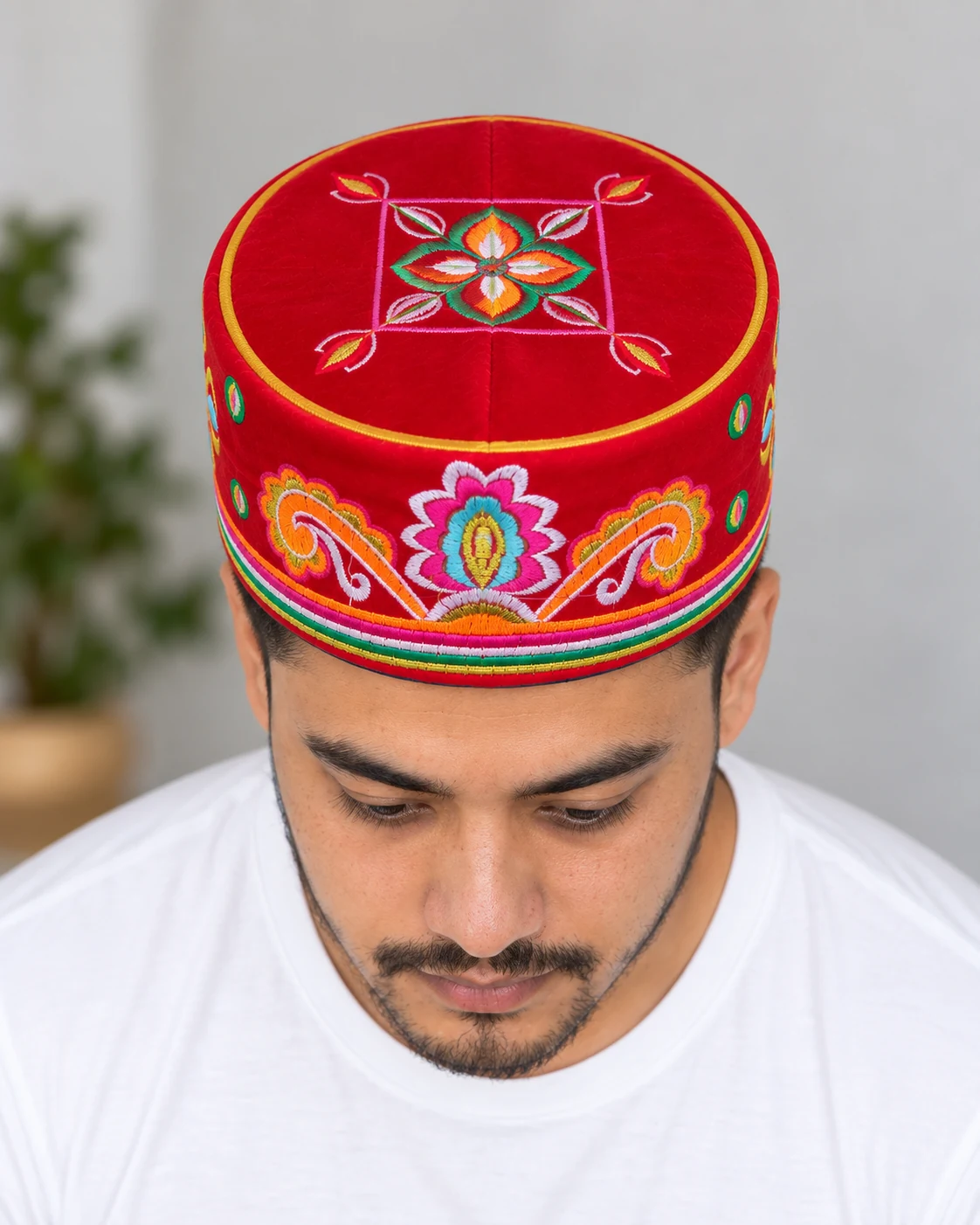 Embroidered Velvet Tamang Topi for Men 22 Man wearing red embroidered velvet topi top view