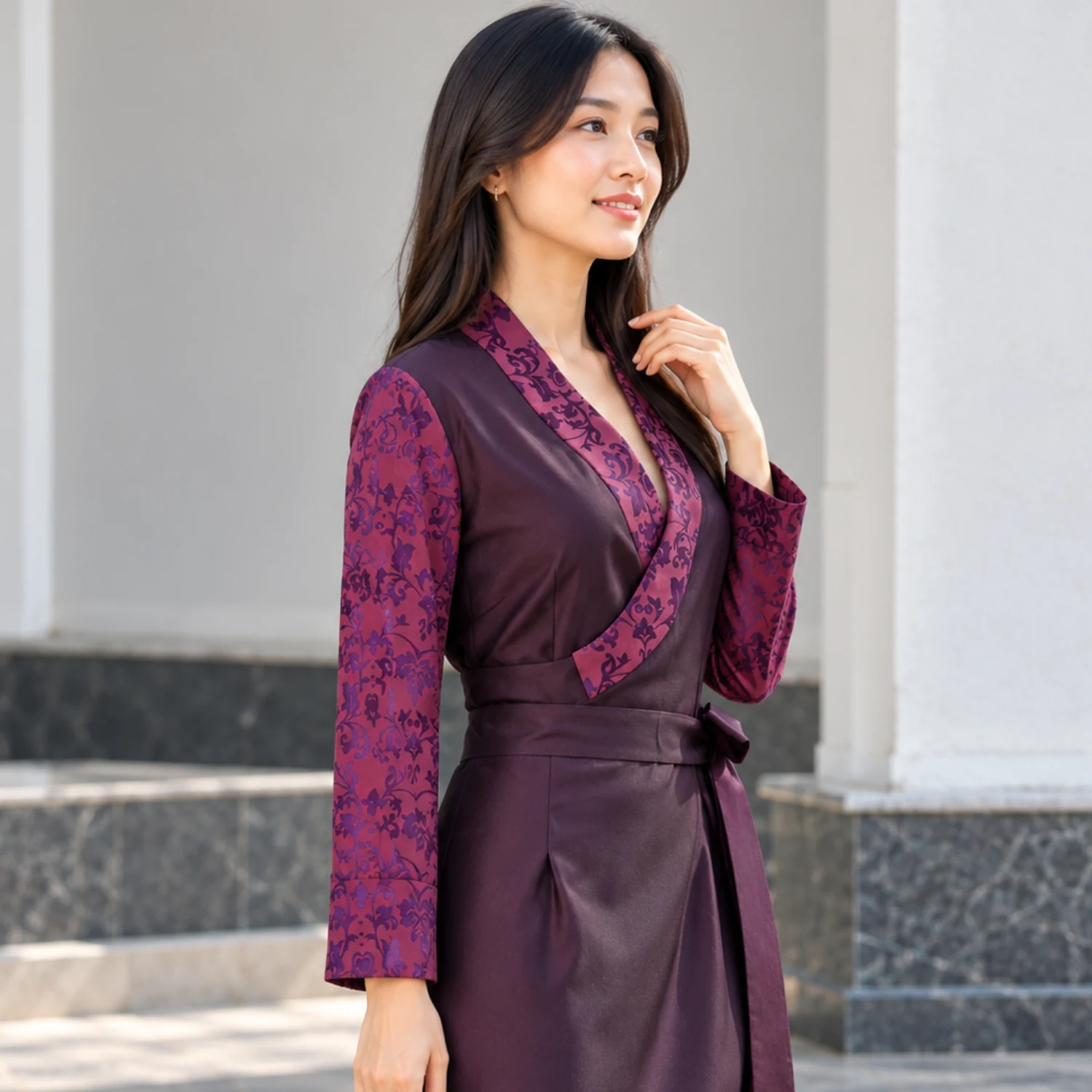 Bhutia Bakhu Dress with Floral Honju Sleeves 3 Woman in plum bakhu with magenta floral honju sleeves three quarter view