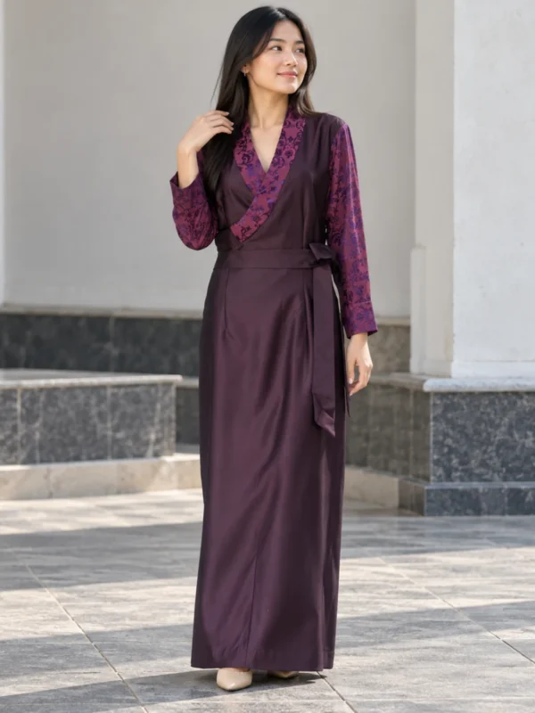 Woman wearing bhutia dress in plum suiting with floral honju sleeves front view