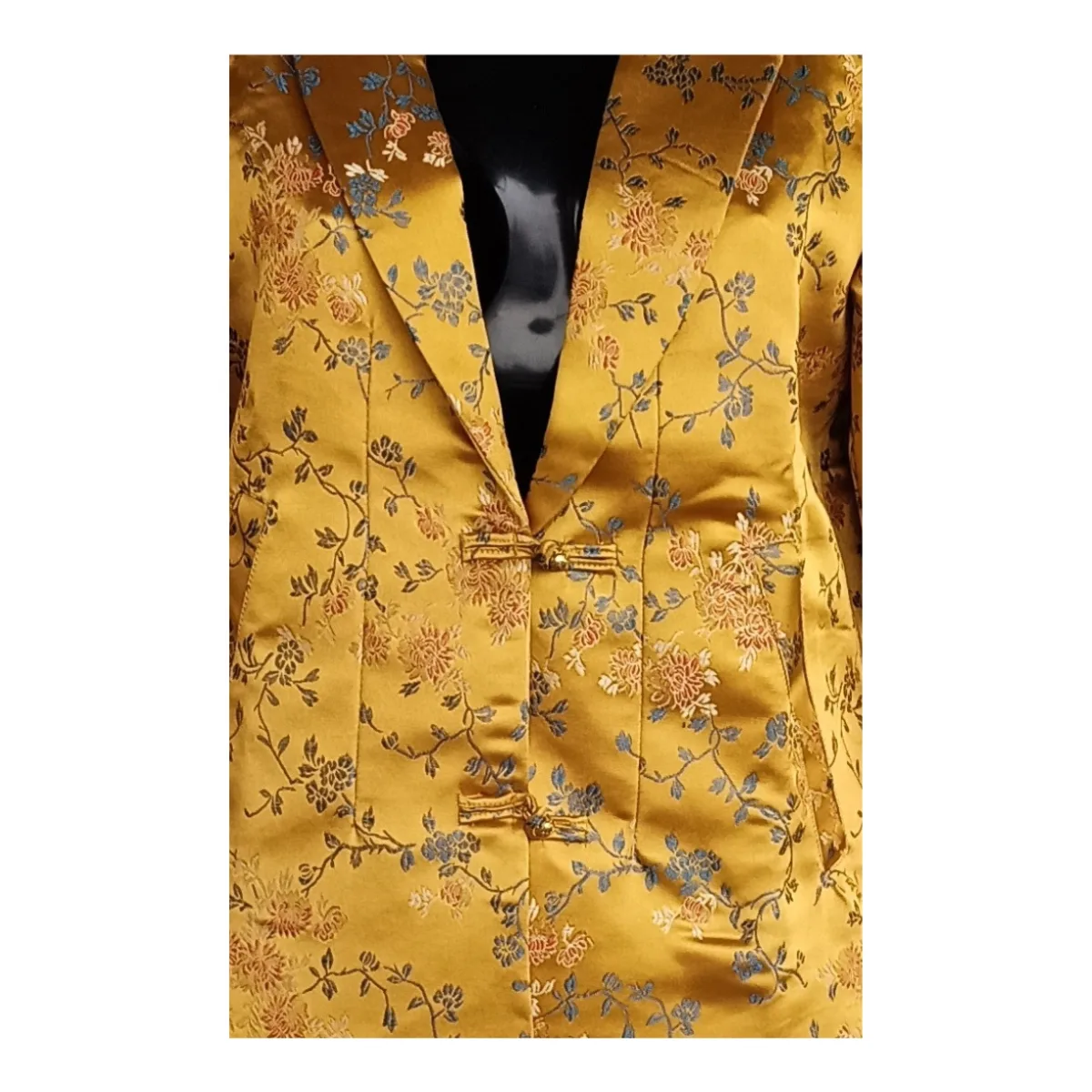 Close-up of floral jacquard and button loops on women’s Kuchin jacket