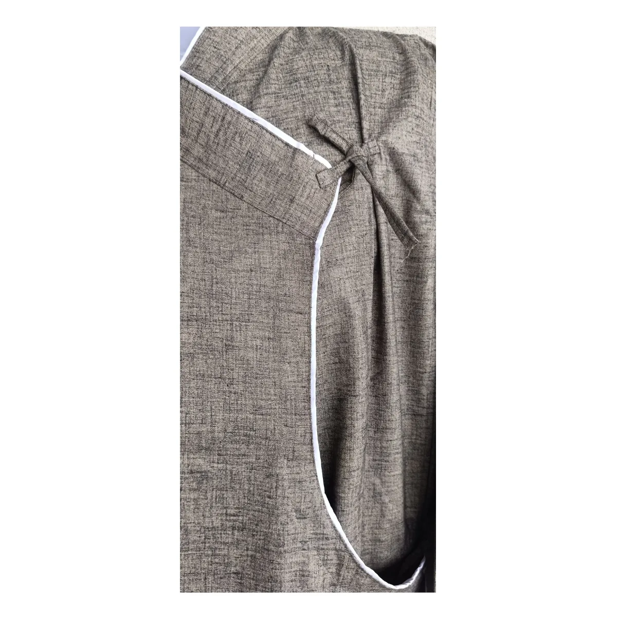 Close-up of white piping and tie knot on charcoal cotton Daura