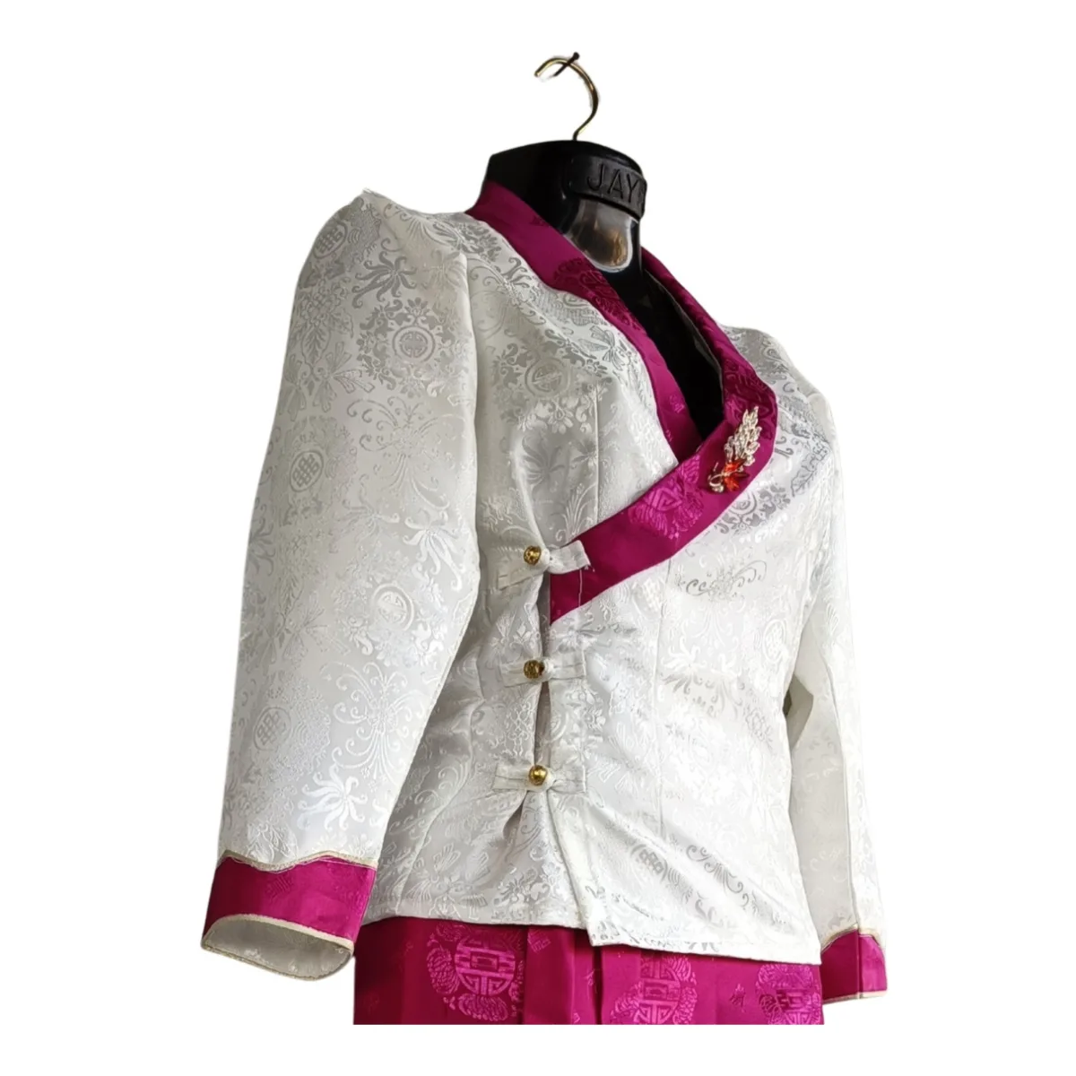 Close-up of ivory jacket with fuchsia border and gold buttons – bakhu top detail
