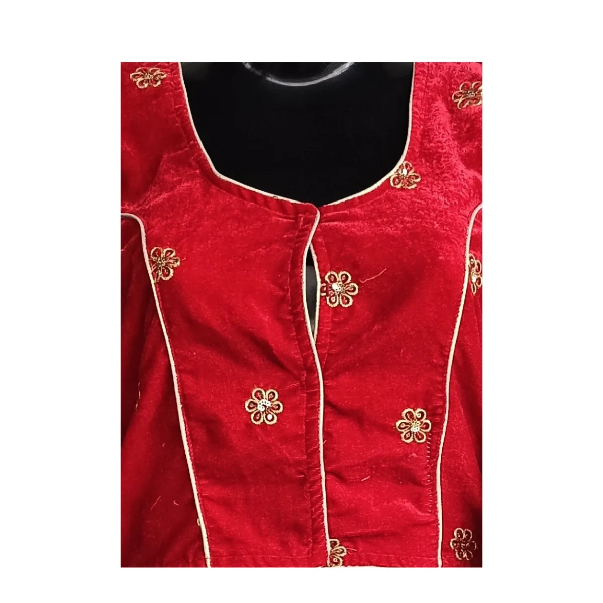 Close view of red velvet butti motifs and contrast piping on Nepali blouse