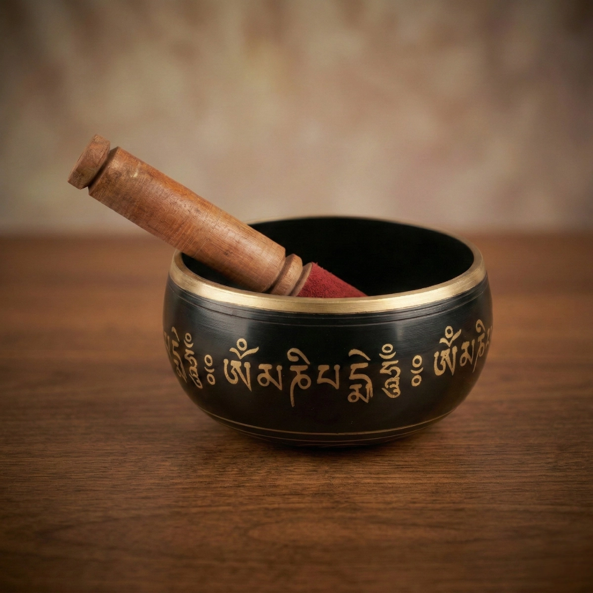 Tibetan singing bowl with Om Mani Padme Hum engraving — matte black brass, gold rim — meditation puja